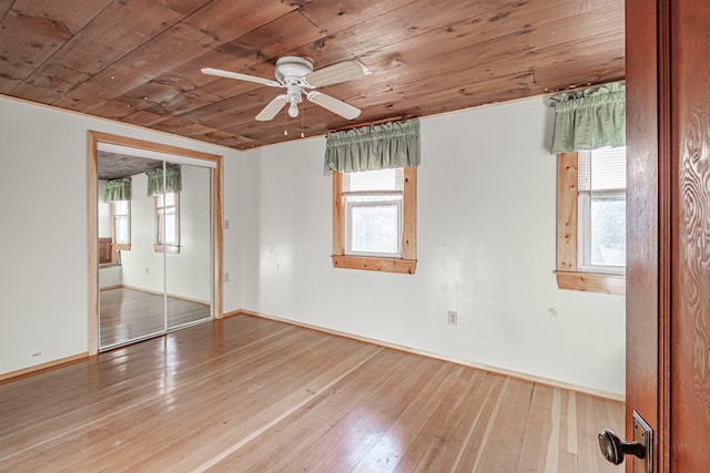 unfurnished bedroom with wooden ceiling, a closet, ceiling fan, and wood-type flooring