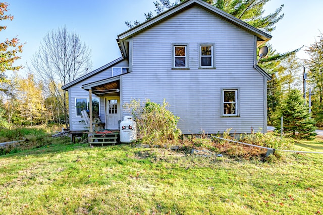 rear view of house with a lawn