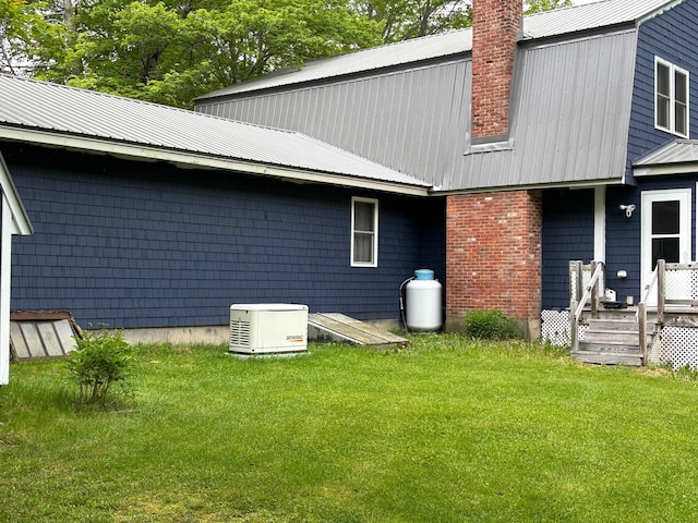 rear view of house featuring a lawn