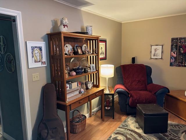 living area featuring ornamental molding and light wood-type flooring