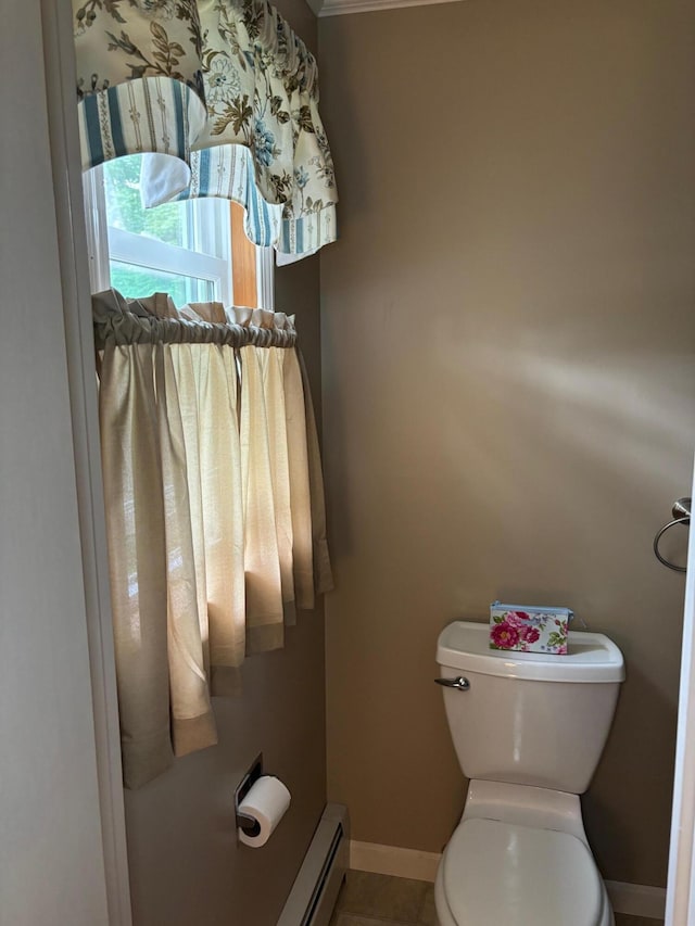 bathroom featuring baseboard heating, tile patterned floors, and toilet