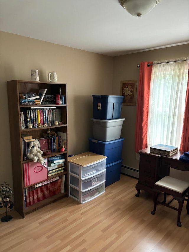 storage room with a baseboard heating unit