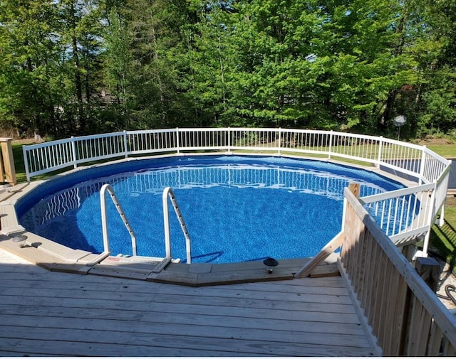 view of swimming pool with a wooden deck