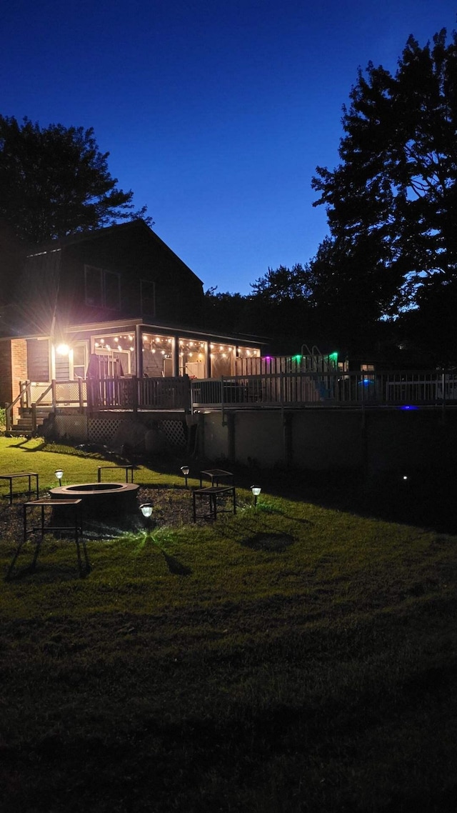 yard at twilight with a wooden deck