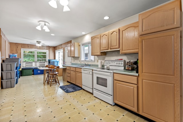 kitchen with ceiling fan, wood walls, white appliances, and light brown cabinetry