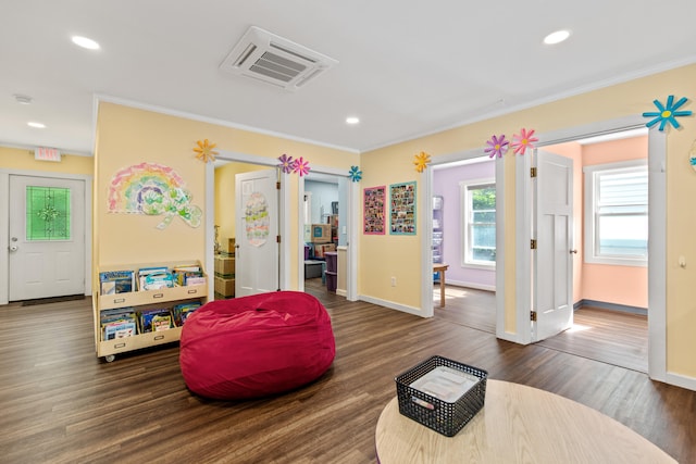 interior space with crown molding and dark hardwood / wood-style flooring