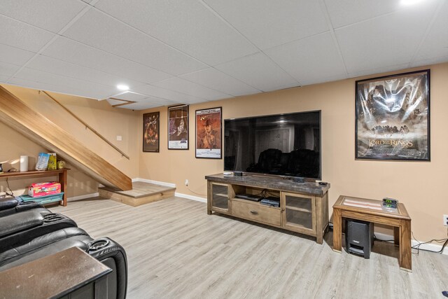 living room featuring hardwood / wood-style flooring and a drop ceiling