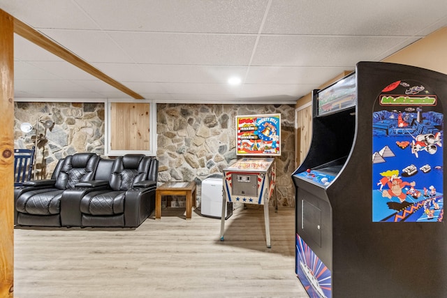 living room featuring wood-type flooring and a drop ceiling