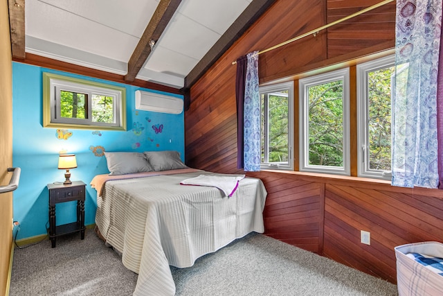 carpeted bedroom featuring an AC wall unit and wooden walls