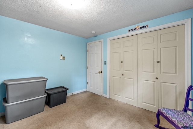 living area featuring a textured ceiling and light carpet