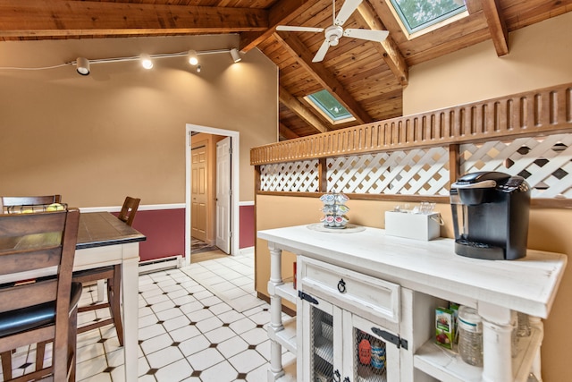 interior space with vaulted ceiling with skylight, tile patterned floors, a baseboard heating unit, ceiling fan, and wooden ceiling