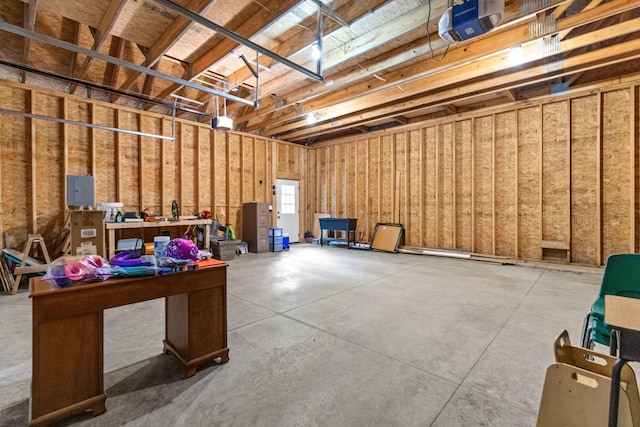 garage featuring a garage door opener and electric panel