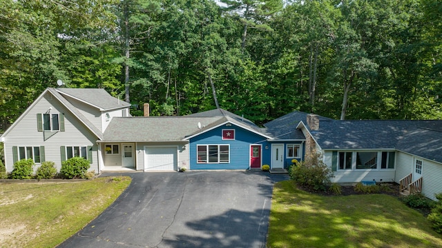 view of front of house with a front yard and a garage