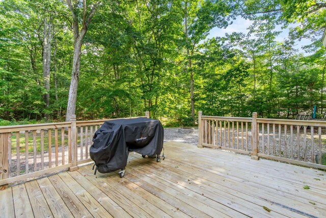 wooden terrace featuring area for grilling