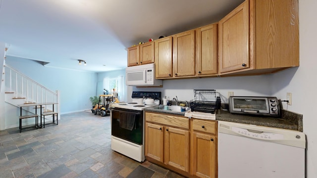 kitchen featuring white appliances and sink