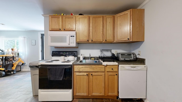 kitchen with sink, white appliances, and crown molding