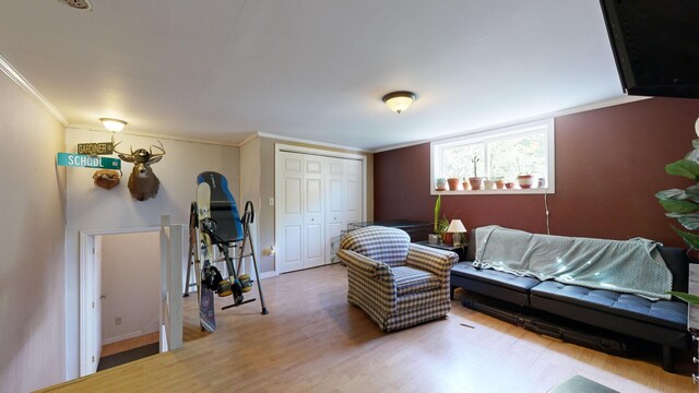 living room featuring wood-type flooring and crown molding