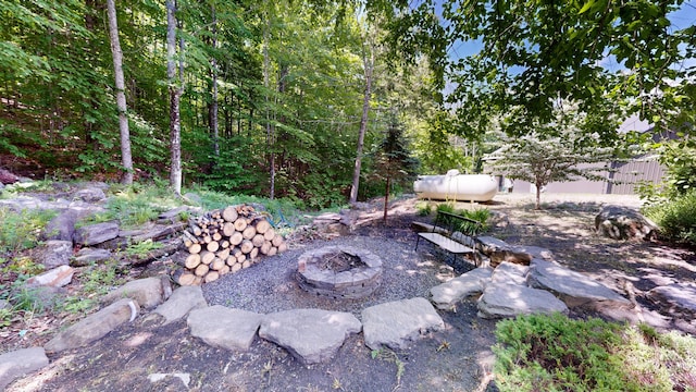 view of yard featuring an outdoor fire pit