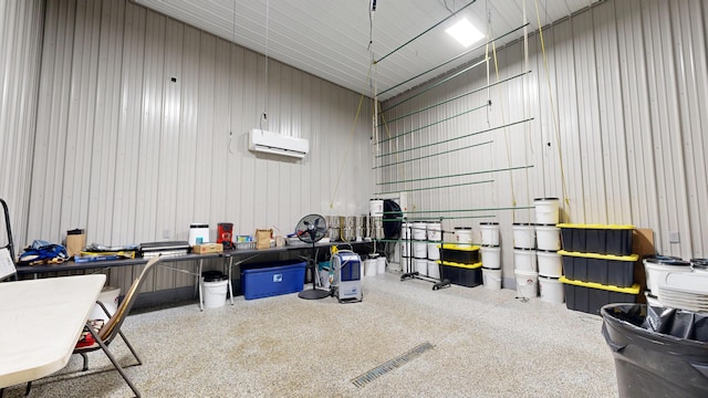 garage featuring an AC wall unit and wooden walls