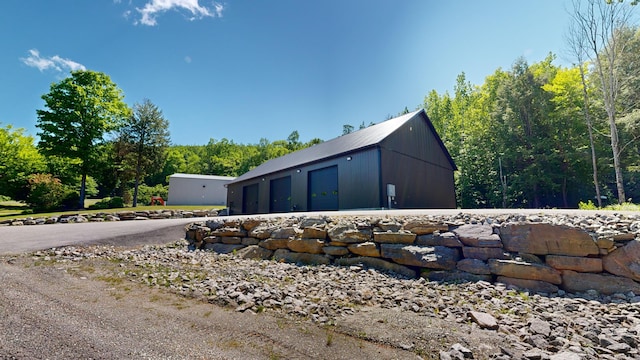 view of side of home featuring an outdoor structure