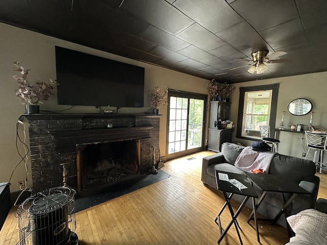 living room with ceiling fan and light hardwood / wood-style flooring