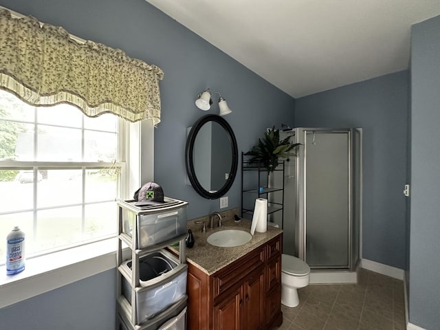 bathroom featuring vanity, toilet, a shower with shower door, and tile patterned flooring