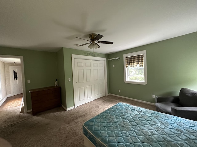 carpeted bedroom with ceiling fan and a closet