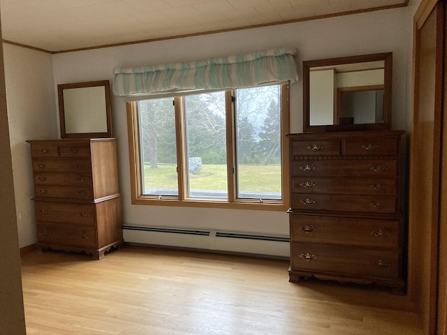 unfurnished bedroom featuring light wood-type flooring, ornamental molding, and a baseboard radiator