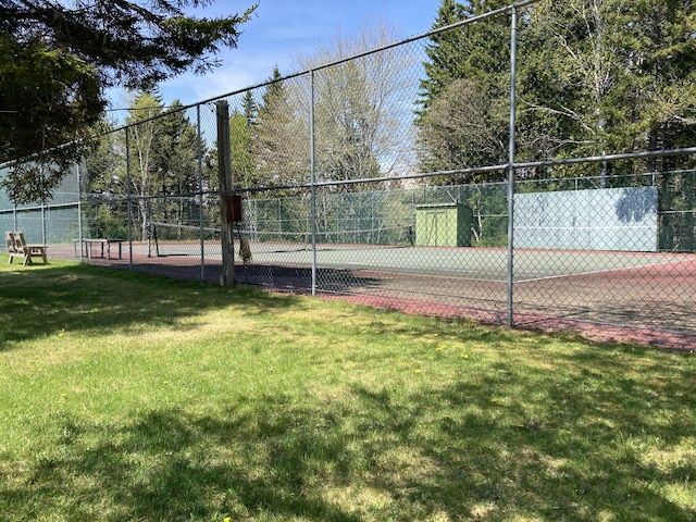 view of sport court featuring a yard