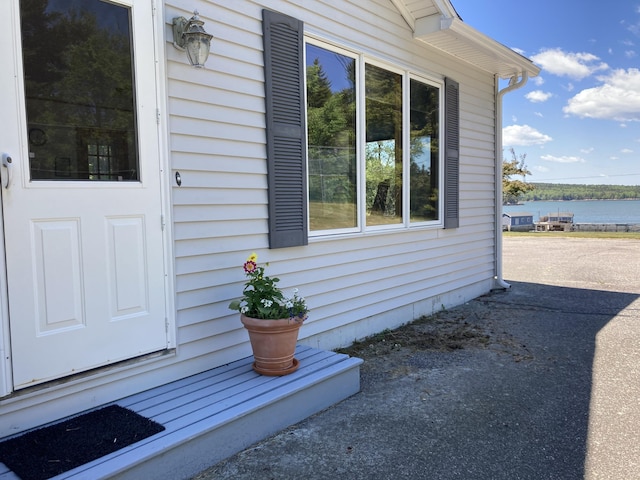 entrance to property with a water view