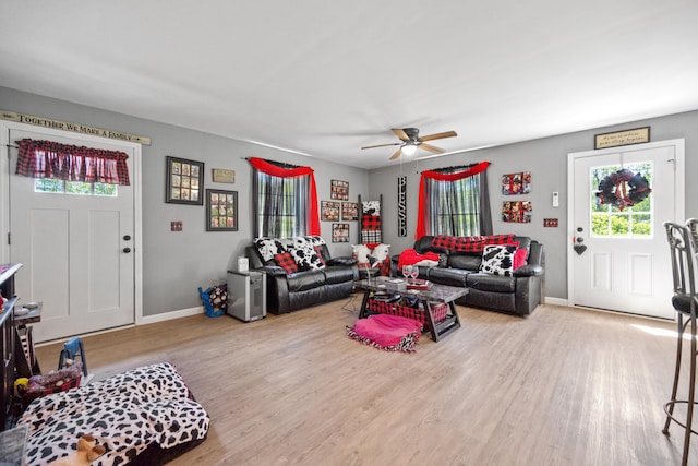 living room featuring ceiling fan and light hardwood / wood-style floors