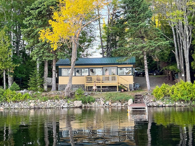 back of property featuring a water view