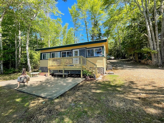 back of house featuring a deck