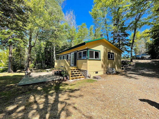 view of side of home with a wooden deck