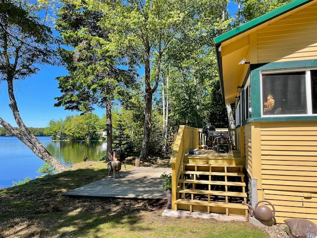 view of yard featuring a deck with water view