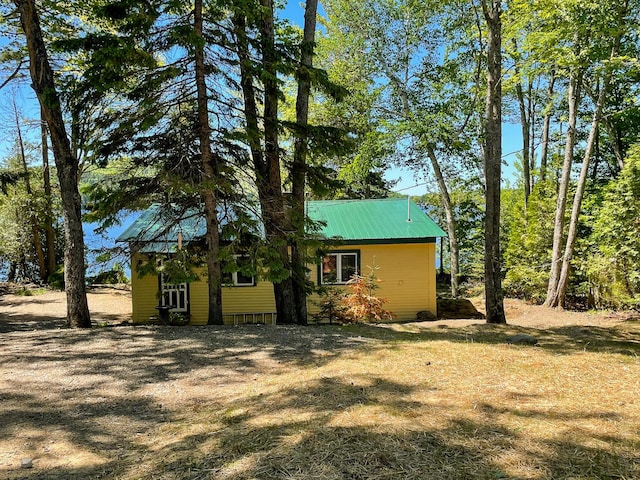 view of side of home featuring a yard