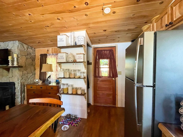 kitchen with lofted ceiling, wood ceiling, stainless steel refrigerator, and dark wood-type flooring