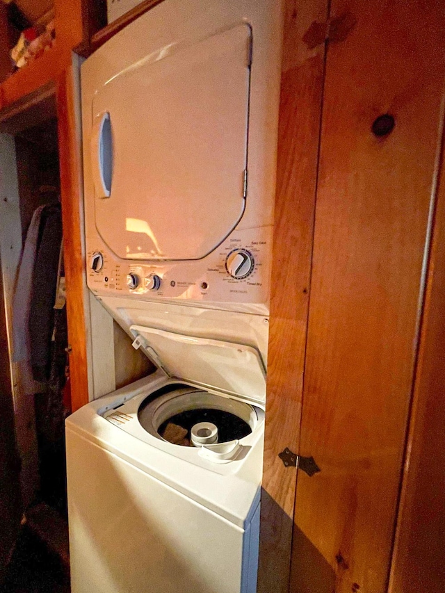 washroom featuring stacked washer / dryer