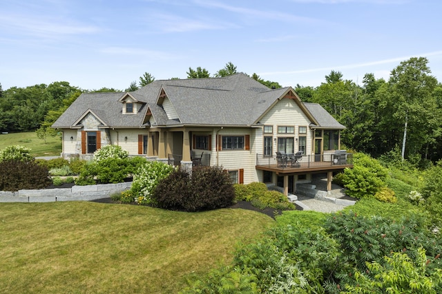 view of front of house featuring a deck and a front yard