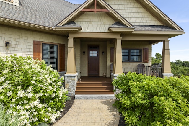 view of exterior entry featuring a porch