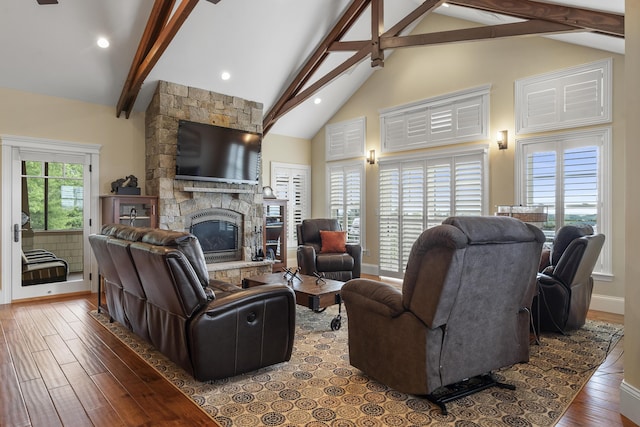 living room featuring a fireplace, beam ceiling, hardwood / wood-style floors, and high vaulted ceiling