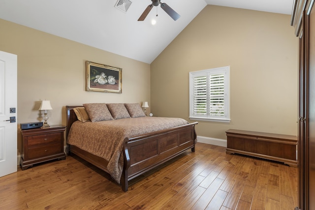 bedroom with ceiling fan, wood-type flooring, and high vaulted ceiling