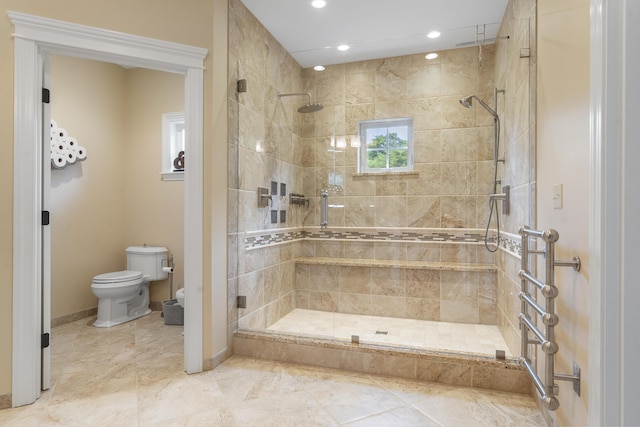 bathroom featuring toilet and a shower with door