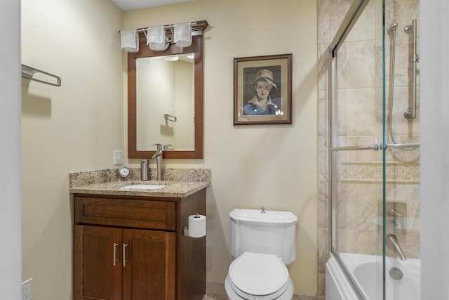 full bathroom with shower / bath combination with glass door, vanity, and toilet