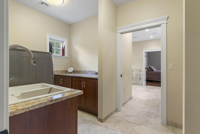 clothes washing area with sink