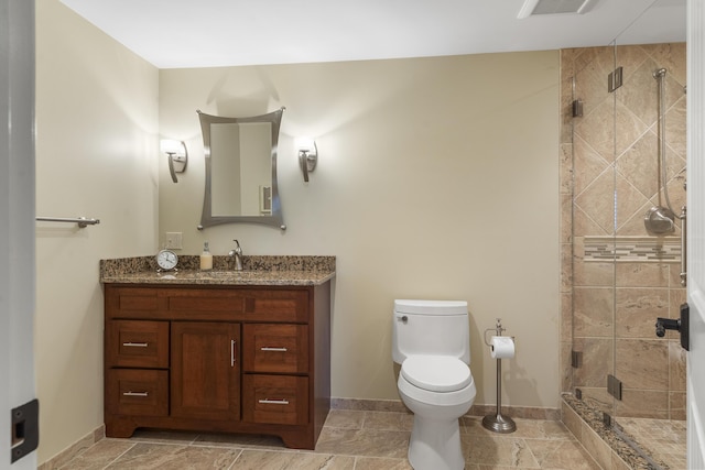 bathroom featuring vanity, toilet, and walk in shower