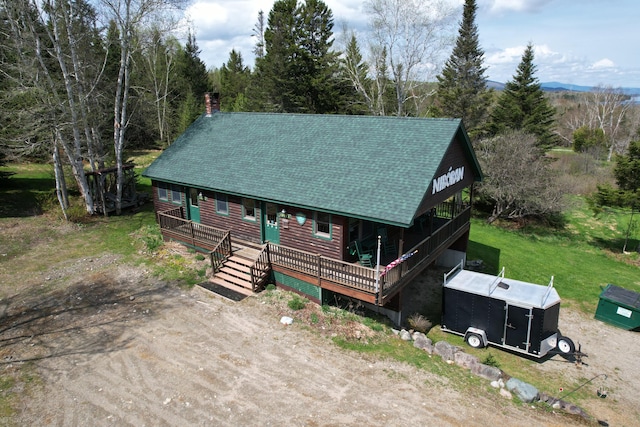 log-style house with a wooden deck