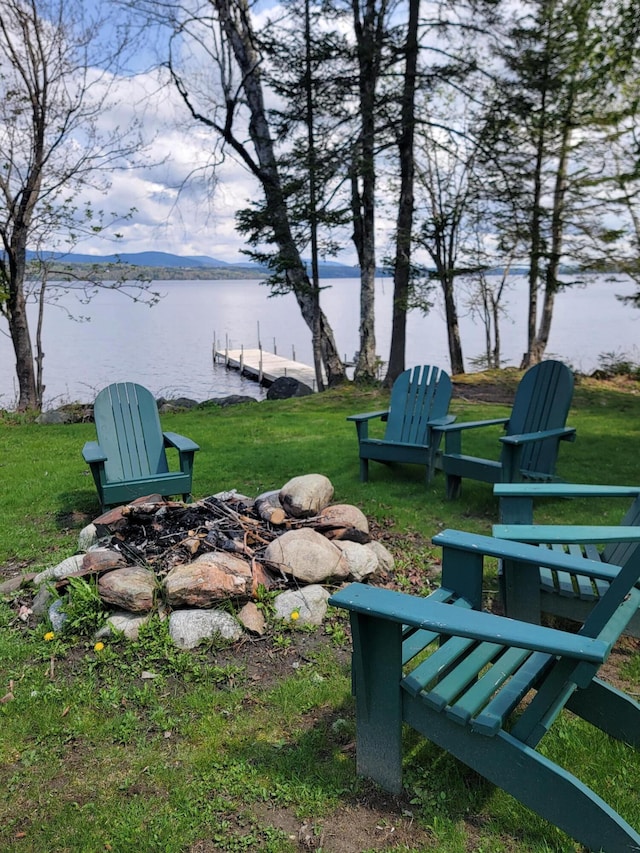 view of yard with a water view and a boat dock