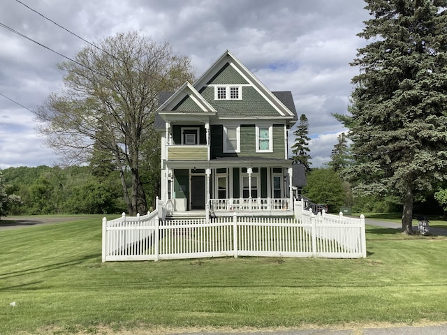 view of front of house featuring covered porch and a front yard