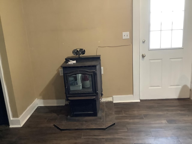 room details featuring hardwood / wood-style floors and a wood stove